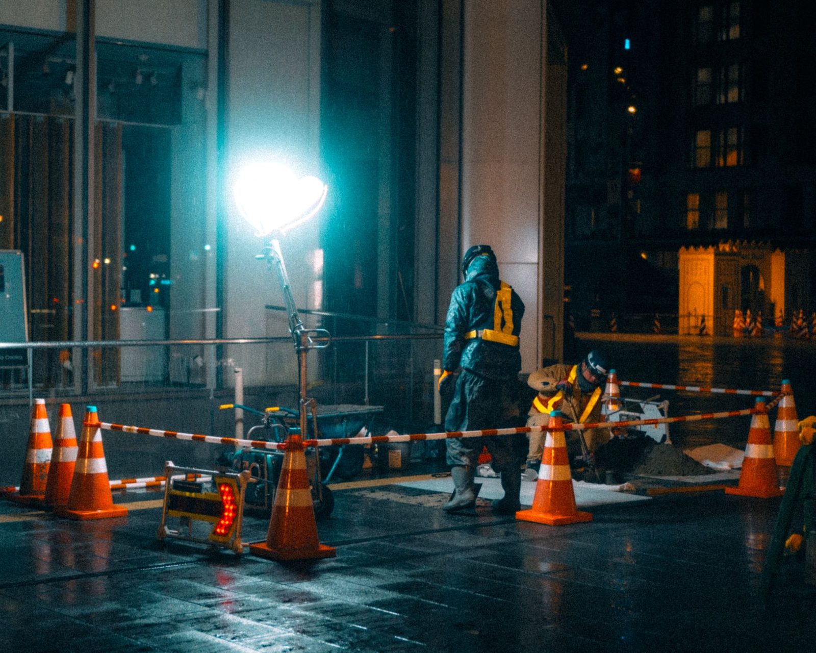 A night work zone lit up with cones