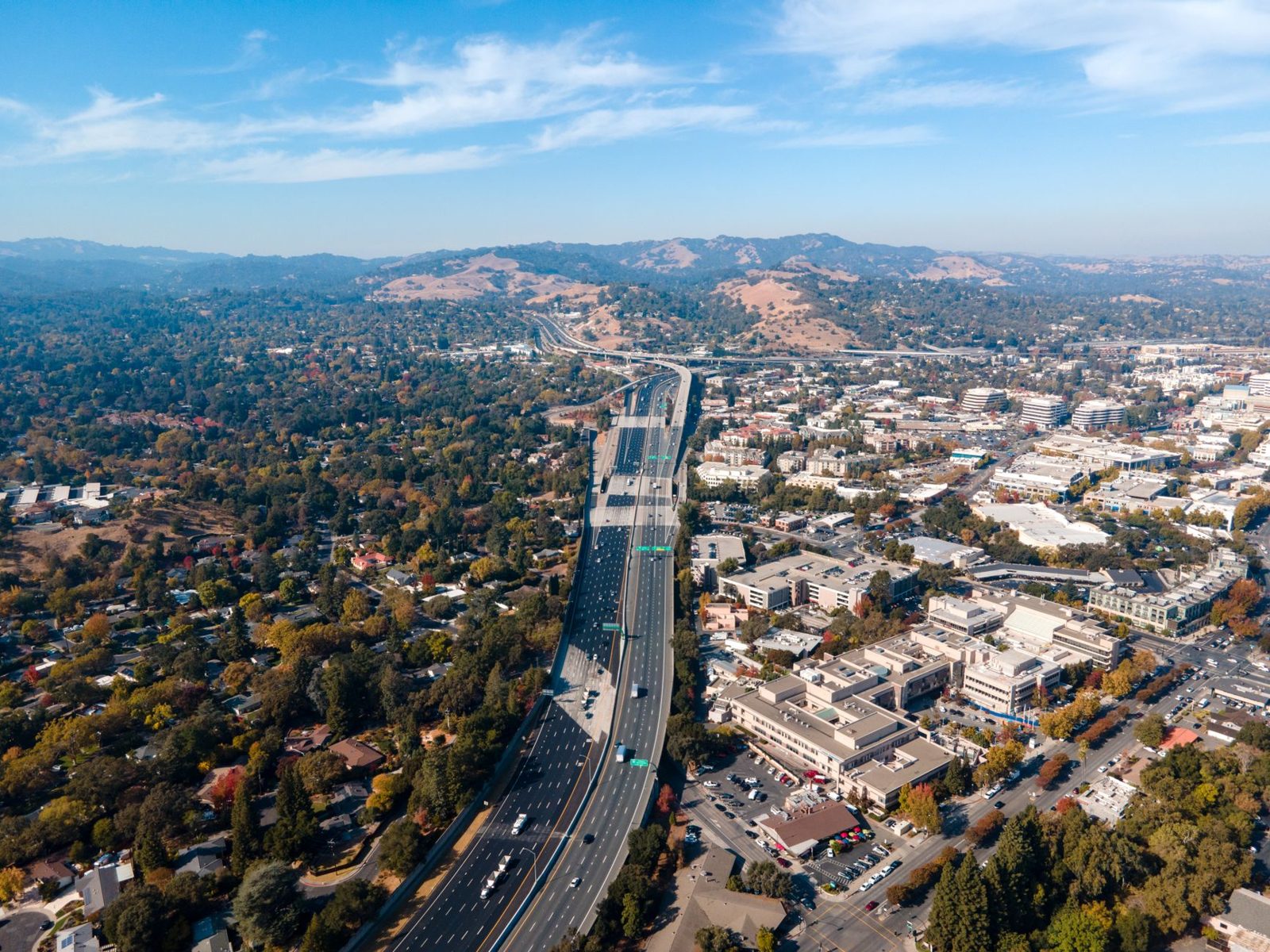 A freeway winding through hills above the valley