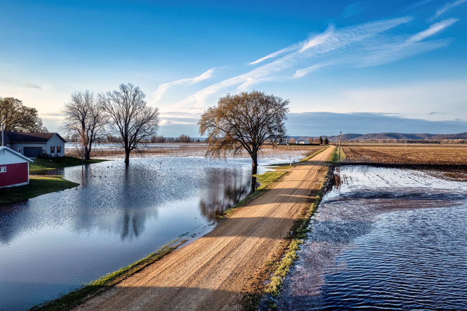 A farm road running through flooded fields
