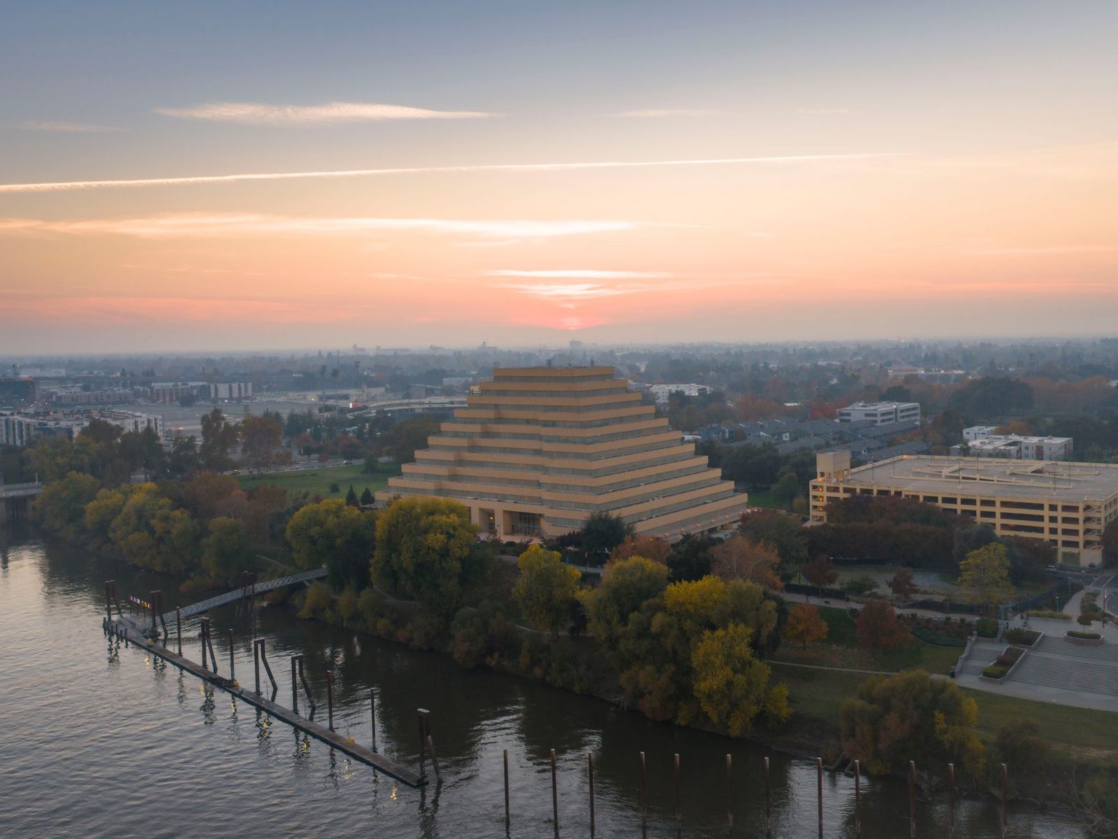 A pyramid shaped office building on the Sacramento riverfront at sunset