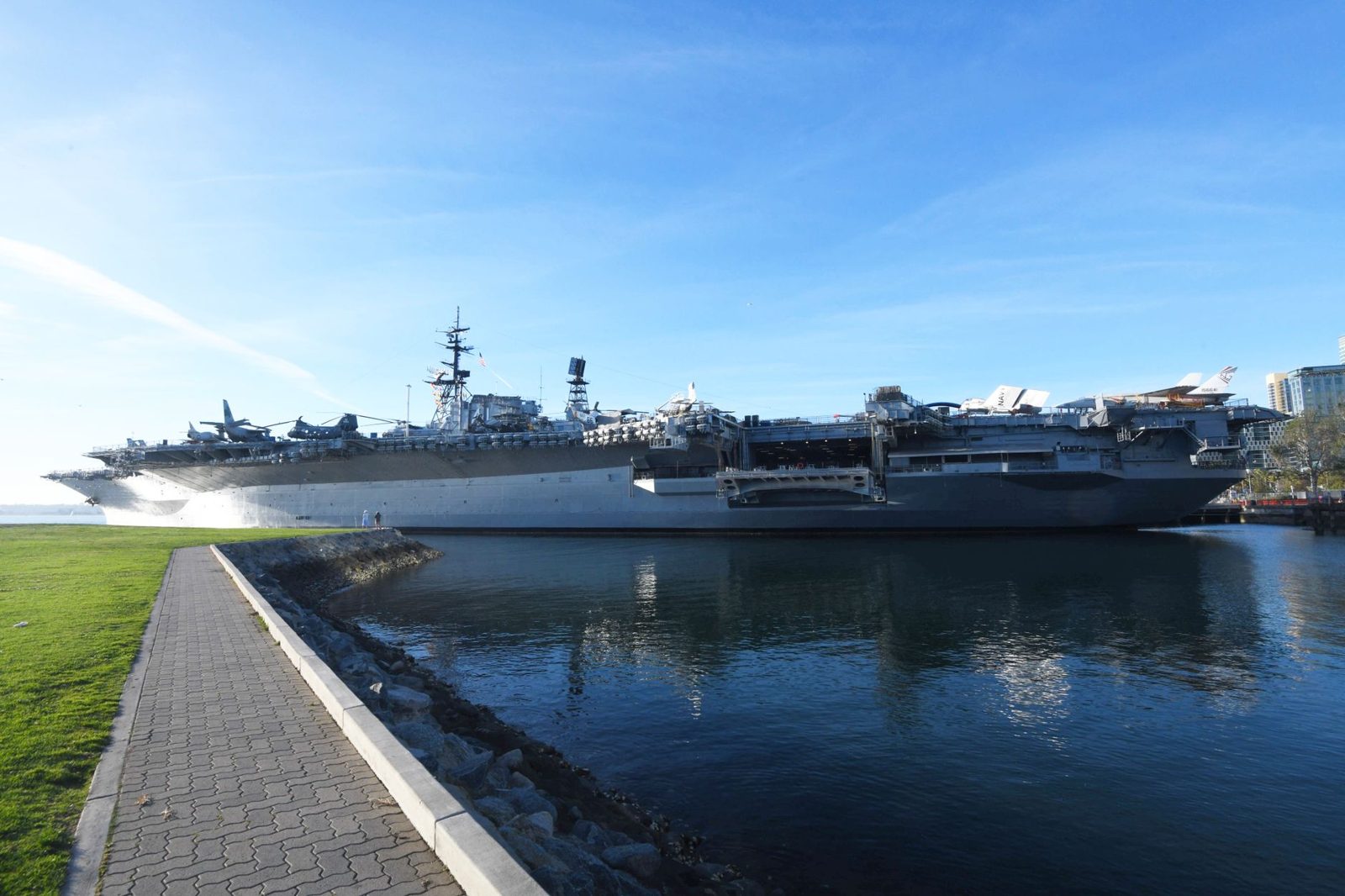 An aircraft carrier moored along the San Diego waterfront