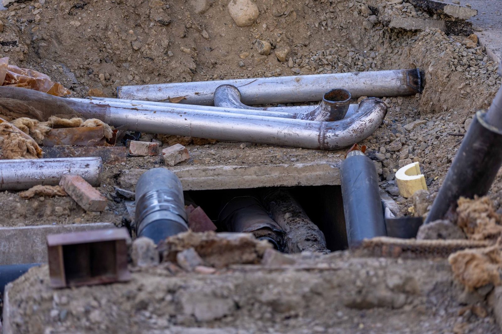 Exposed pipes in a street excavation