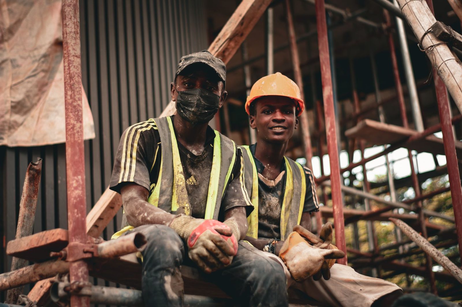 Two workers in hard hats taking a break on a jobsite