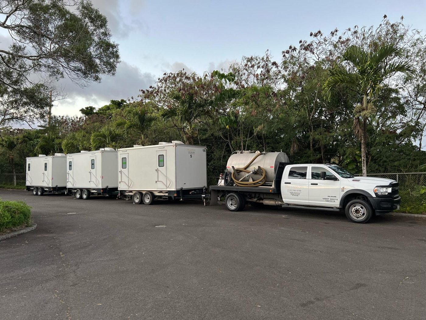Convoy of white support trailers staged with a service truck for a field deployment