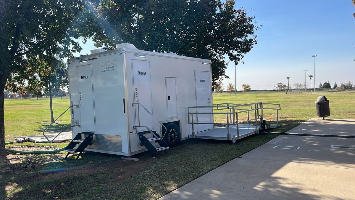 Roll in ADA shower trailer with ramp entry and two conventional stall doors