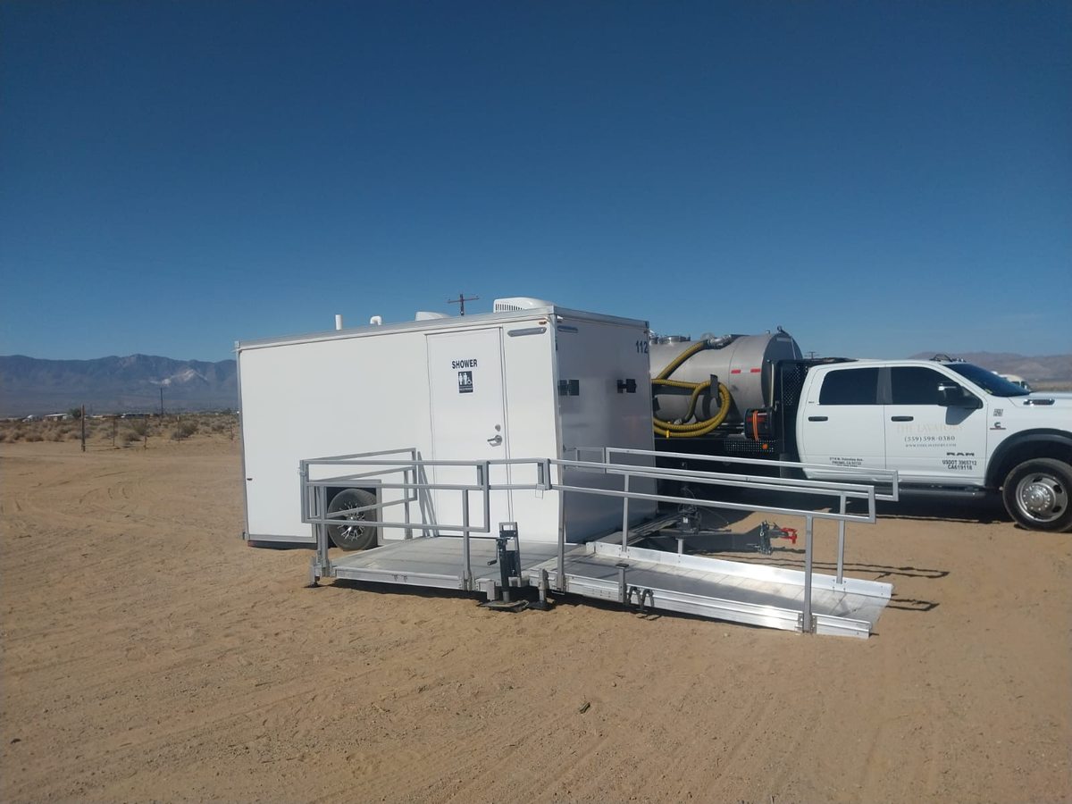 Single ramped suite combining wheelchair accessible shower, toilet and sink in one trailer