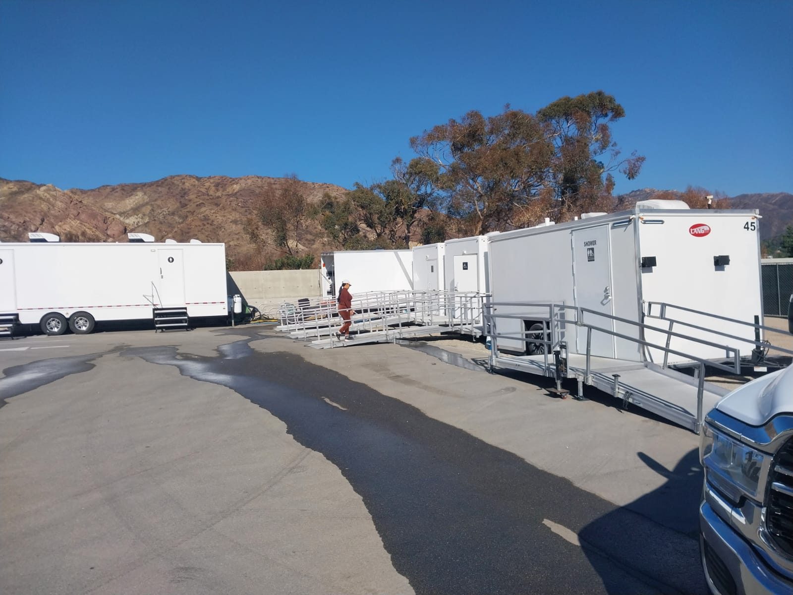 Rows of trailers forming a full crew basecamp with vehicles staged along the perimeter