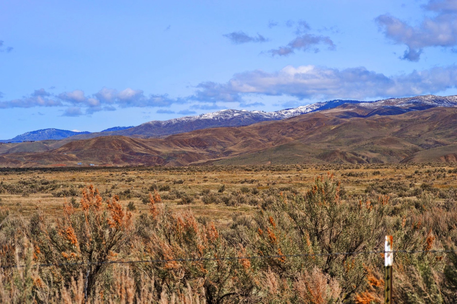 A laundry trailer parked at a remote Nevada mine or fire camp in the high desert, with dry mountains in the background