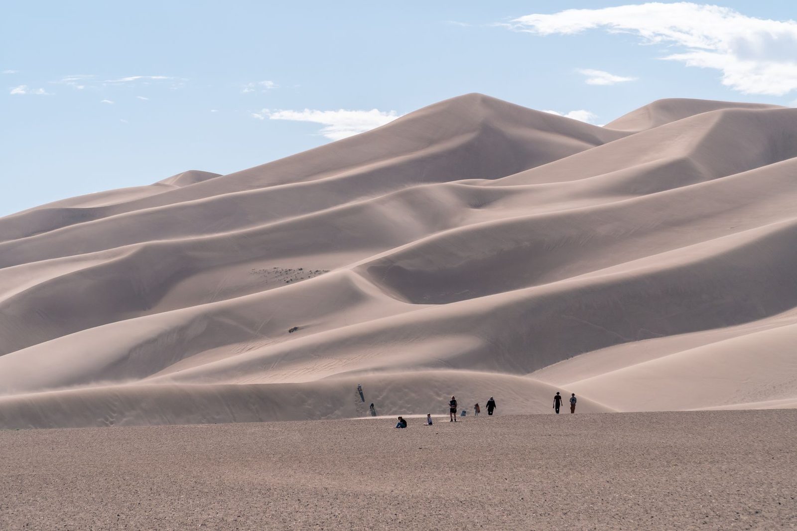 Hikers crossing Great Sand Dunes National Park in the San Luis Valley