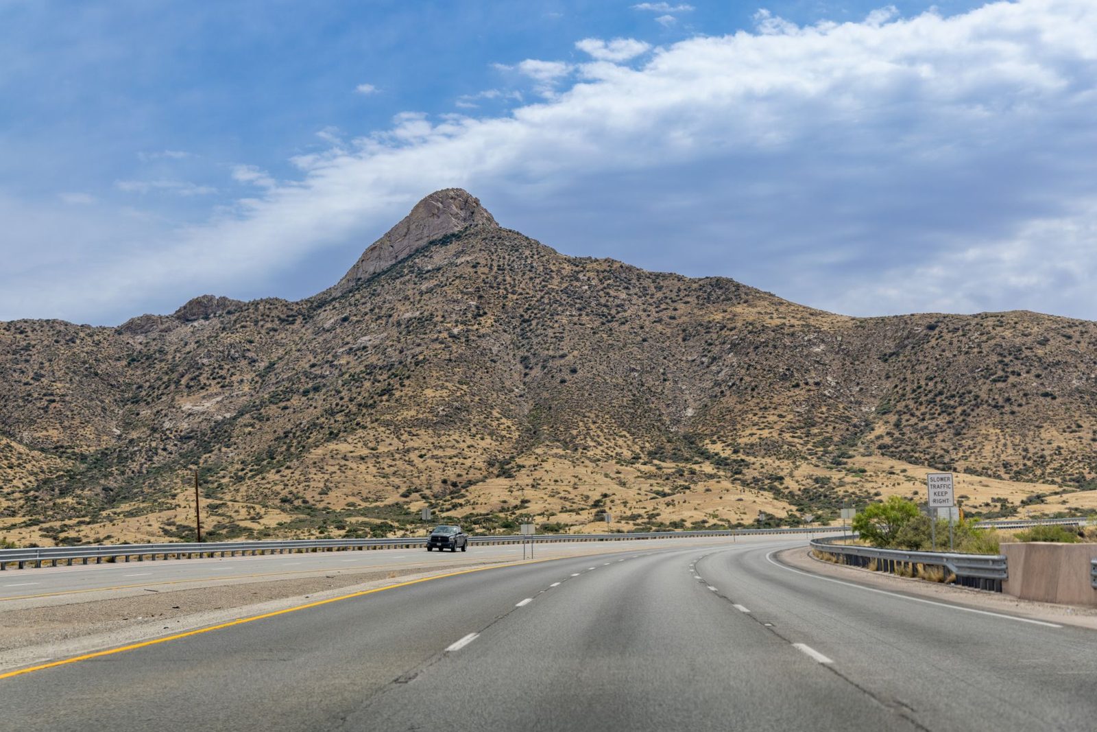 A highway passing a rocky peak in far West Texas