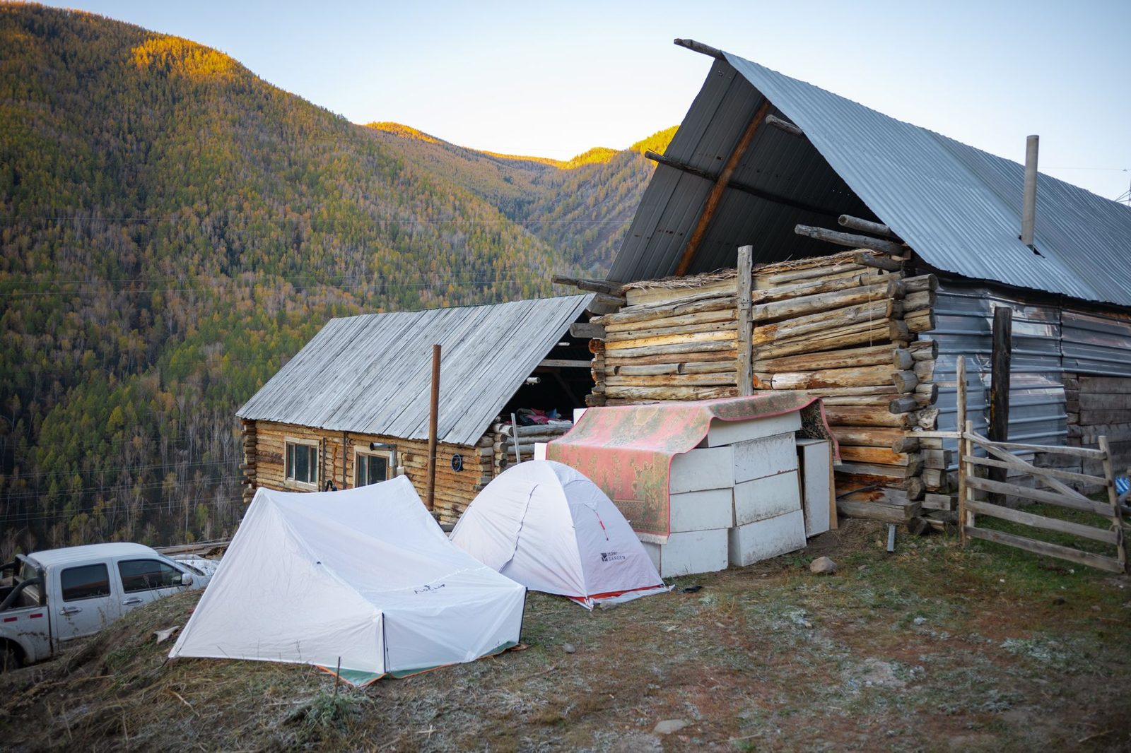 Cabins and tents at a mountain camp in cold weather