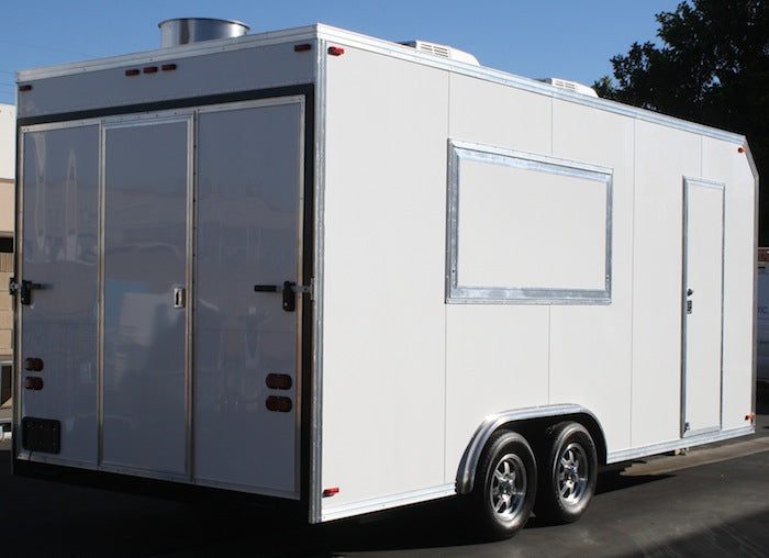 Mobile kitchen trailer set up on site with its service window open ahead of the meal rush
