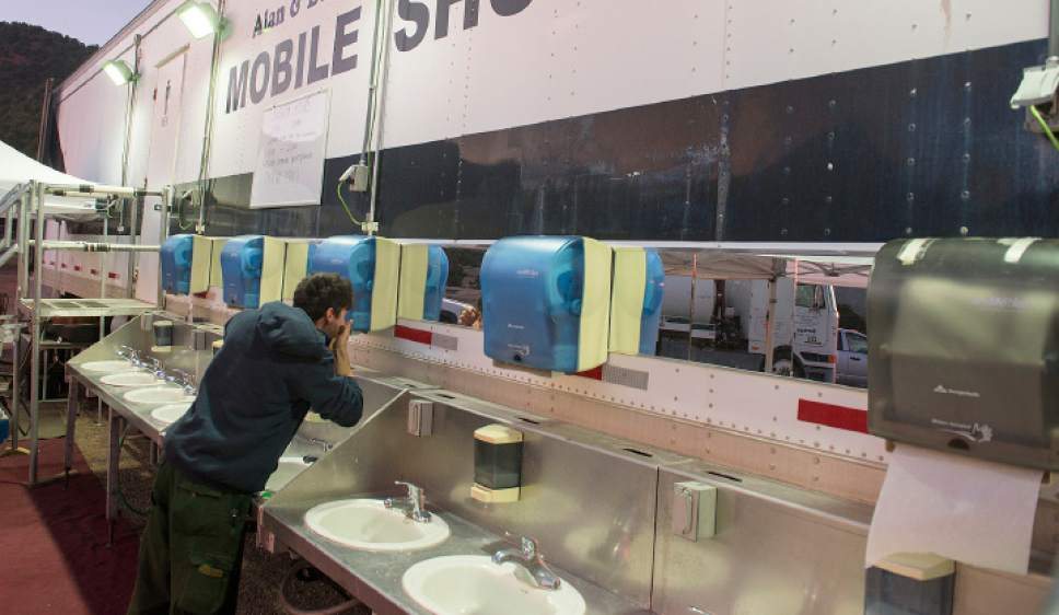 Crews using a mobile shower and handwash line during a sustained field operation