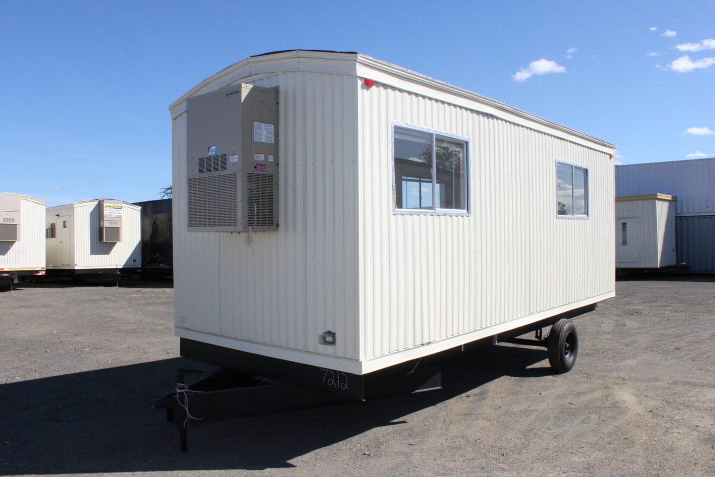 Mobile office trailer with two entry doors and steps on a project site