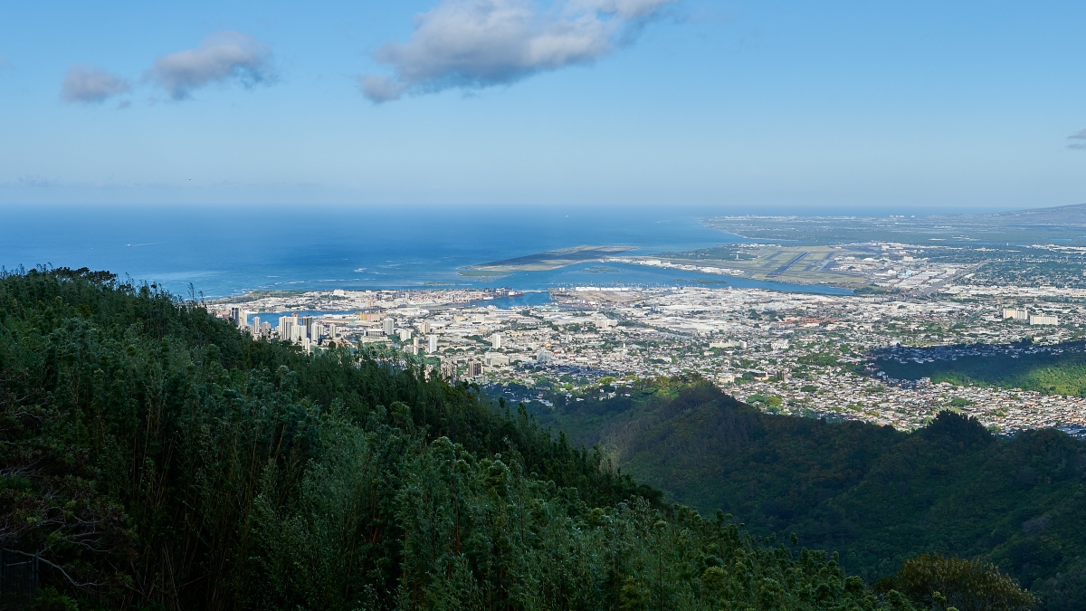 Aerial view of Pearl Harbor and the Honolulu airport reef runway from the Koolau ridge, the military and government corridor on Oahu that Mavirus Group serves