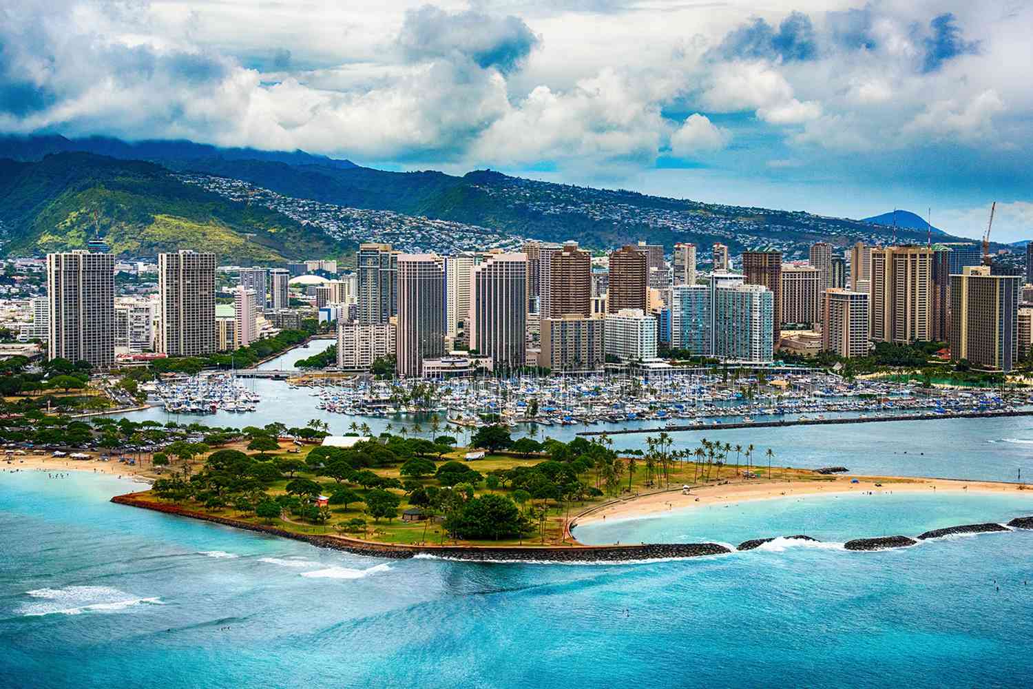 Aerial view of Ala Moana Beach Park and the Honolulu marina and skyline against the Koolau range, the Oahu military and government corridor Mavirus Group serves