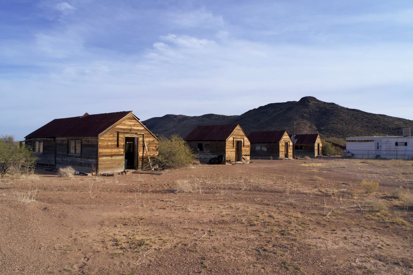 A cluster of small buildings on open desert ground