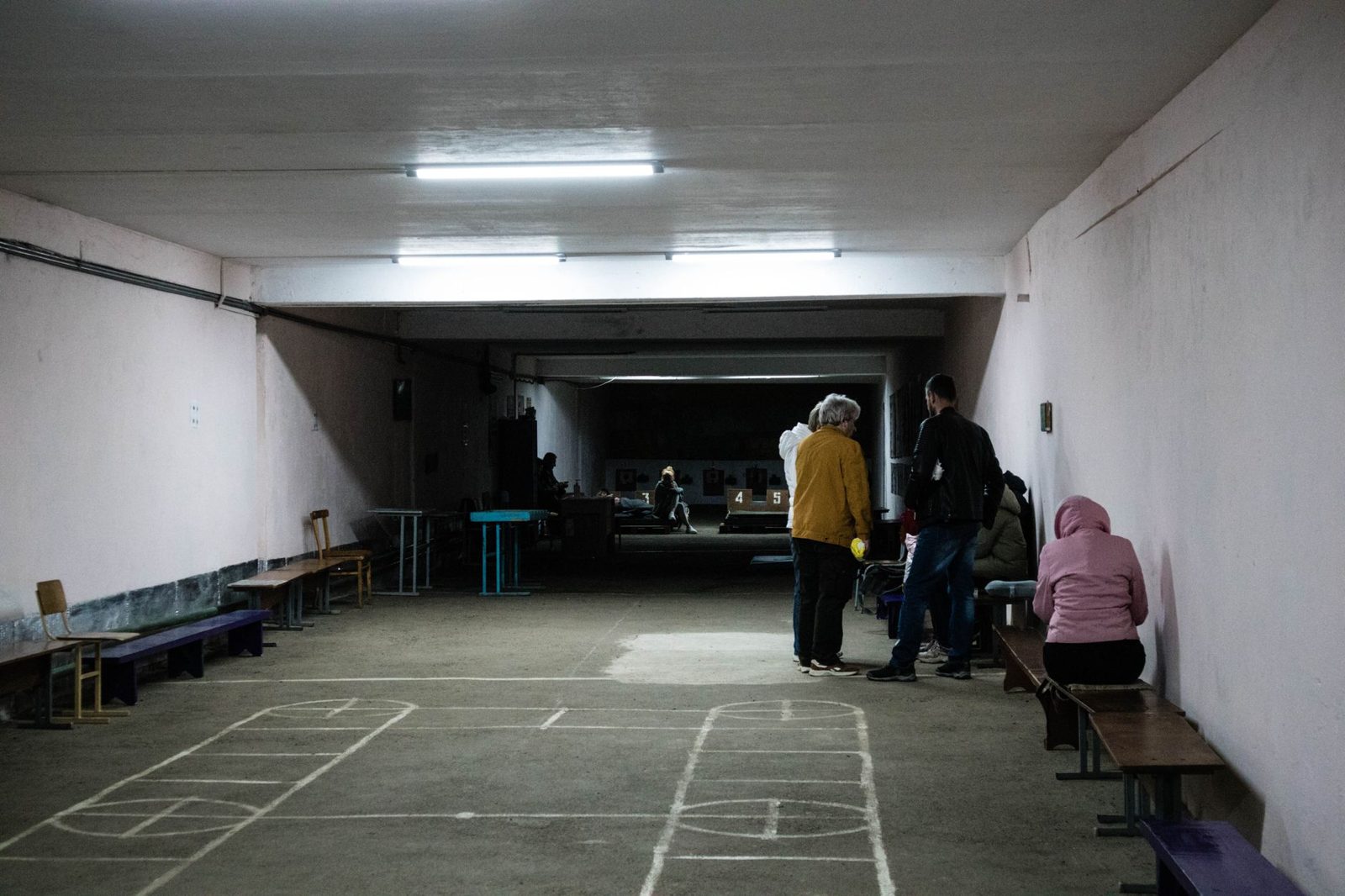 A long indoor hall set up as a shelter space