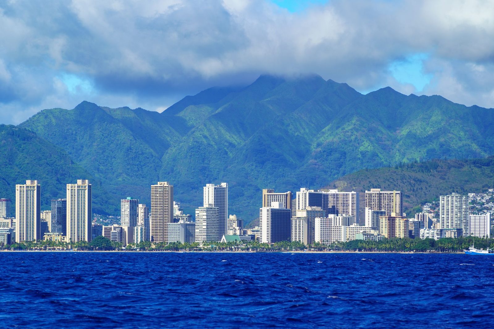 The Honolulu skyline under the green Koolau Range, seen from offshore