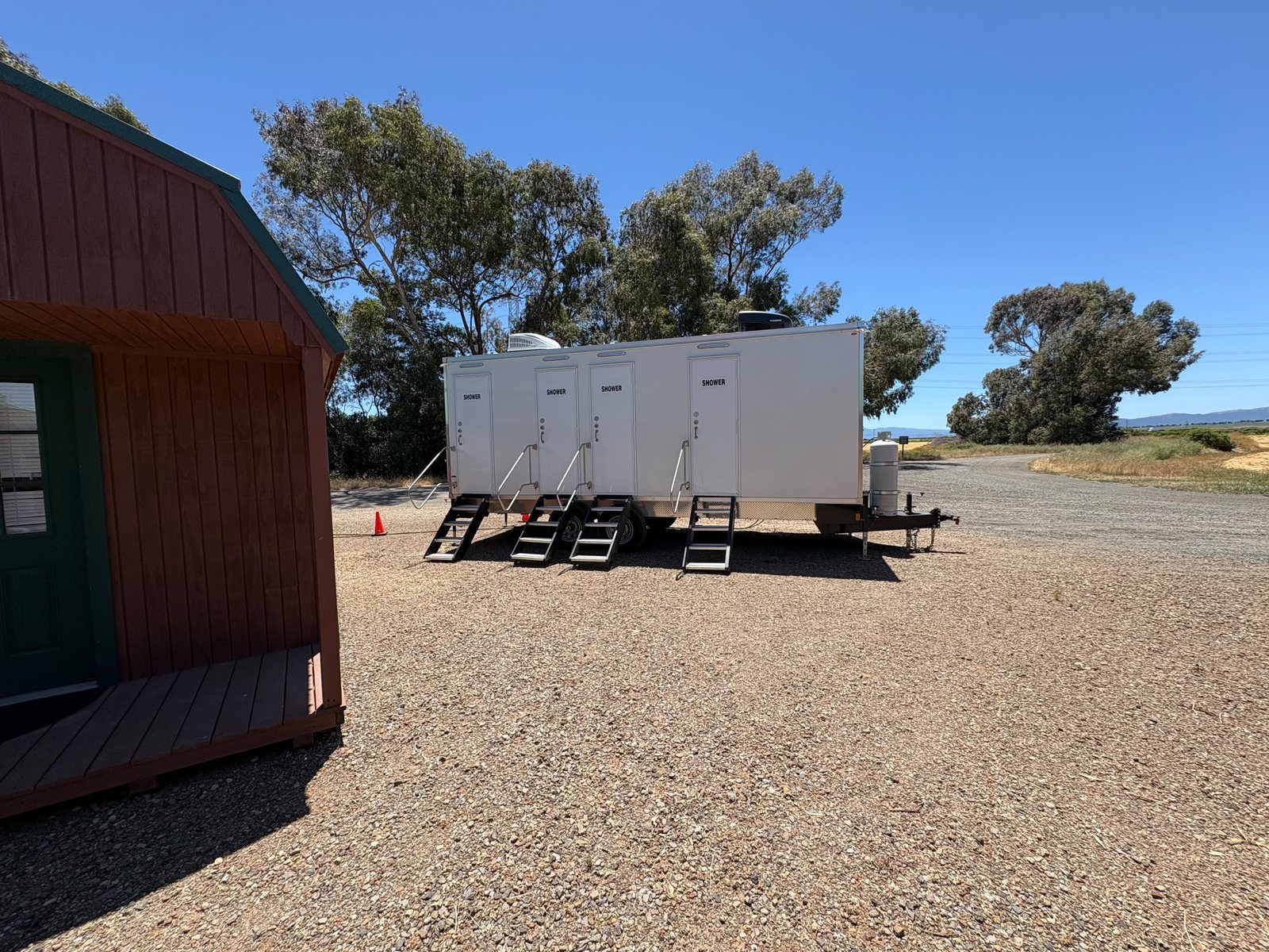 8 station shower trailer staged at the rural gravel lot, an Arizona shower trailer rental job